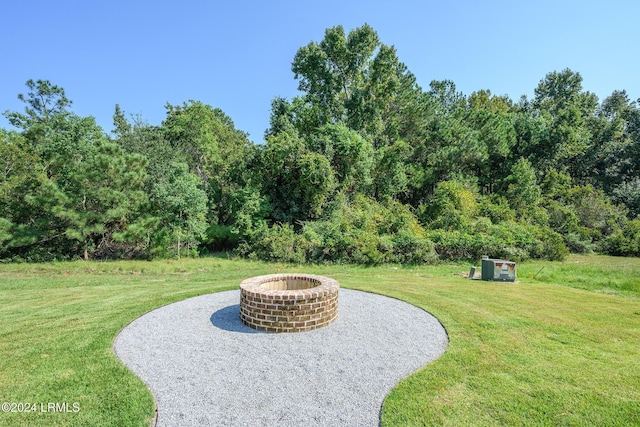 view of yard with an outdoor fire pit