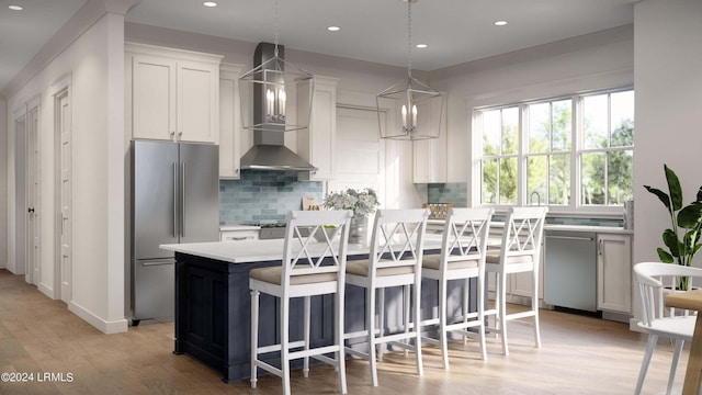 kitchen featuring decorative light fixtures, backsplash, high quality fridge, white cabinetry, and light wood-type flooring