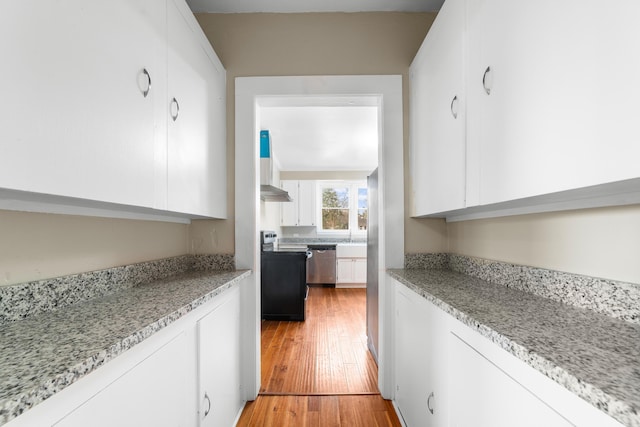 kitchen with light hardwood / wood-style flooring, dishwasher, electric range, light stone countertops, and white cabinets