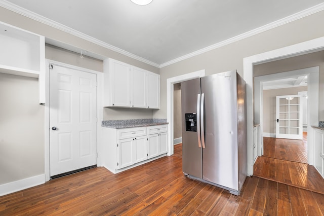 kitchen with ornamental molding, dark hardwood / wood-style floors, stainless steel fridge with ice dispenser, and white cabinets