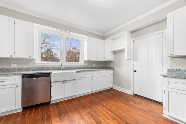 kitchen featuring sink, stainless steel dishwasher, white cabinets, and light stone counters