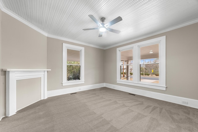 unfurnished living room featuring ornamental molding, carpet, a wealth of natural light, and a fireplace