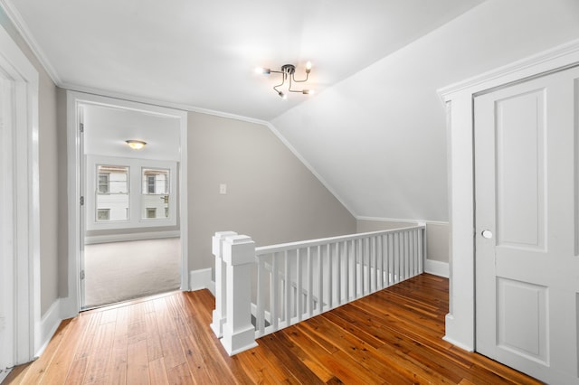 hallway featuring hardwood / wood-style floors and vaulted ceiling