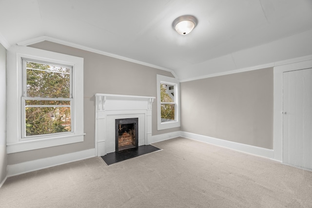 unfurnished living room featuring lofted ceiling, crown molding, and carpet flooring