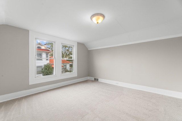 bonus room featuring lofted ceiling and carpet floors