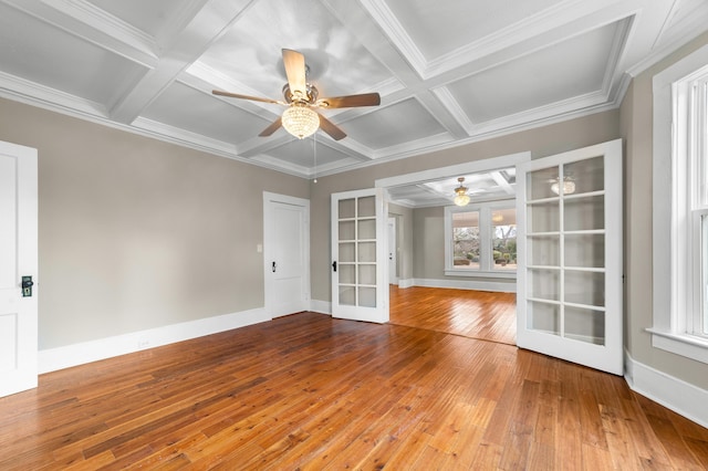 unfurnished room featuring coffered ceiling, hardwood / wood-style flooring, french doors, and beamed ceiling