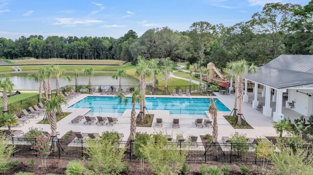 view of pool with a patio area and a water view