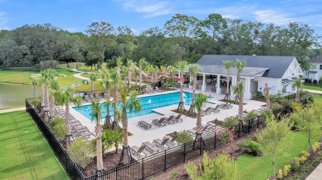 view of pool featuring a water view and a patio