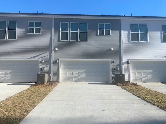 view of front facade featuring central air condition unit and a garage