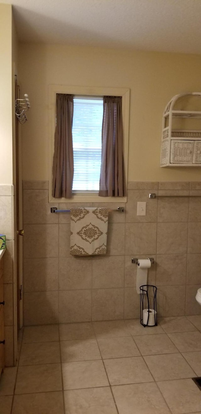 107 Kelly St, Walterboro, SC 29488 - bathroom featuring tile patterned flooring, tile walls, a wainscoted wall, and vanity