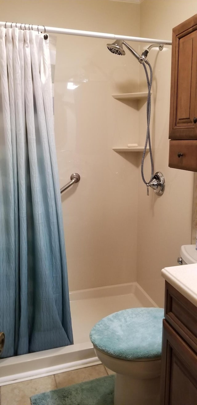 107 Kelly St, Walterboro, SC 29488 - full bath with a shower stall, tile patterned flooring, vanity, and toilet