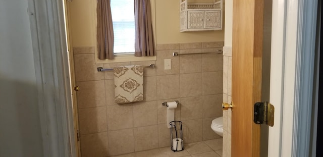 107 Kelly St, Walterboro, SC 29488 - bathroom featuring wainscoting, tile patterned flooring, toilet, and tile walls