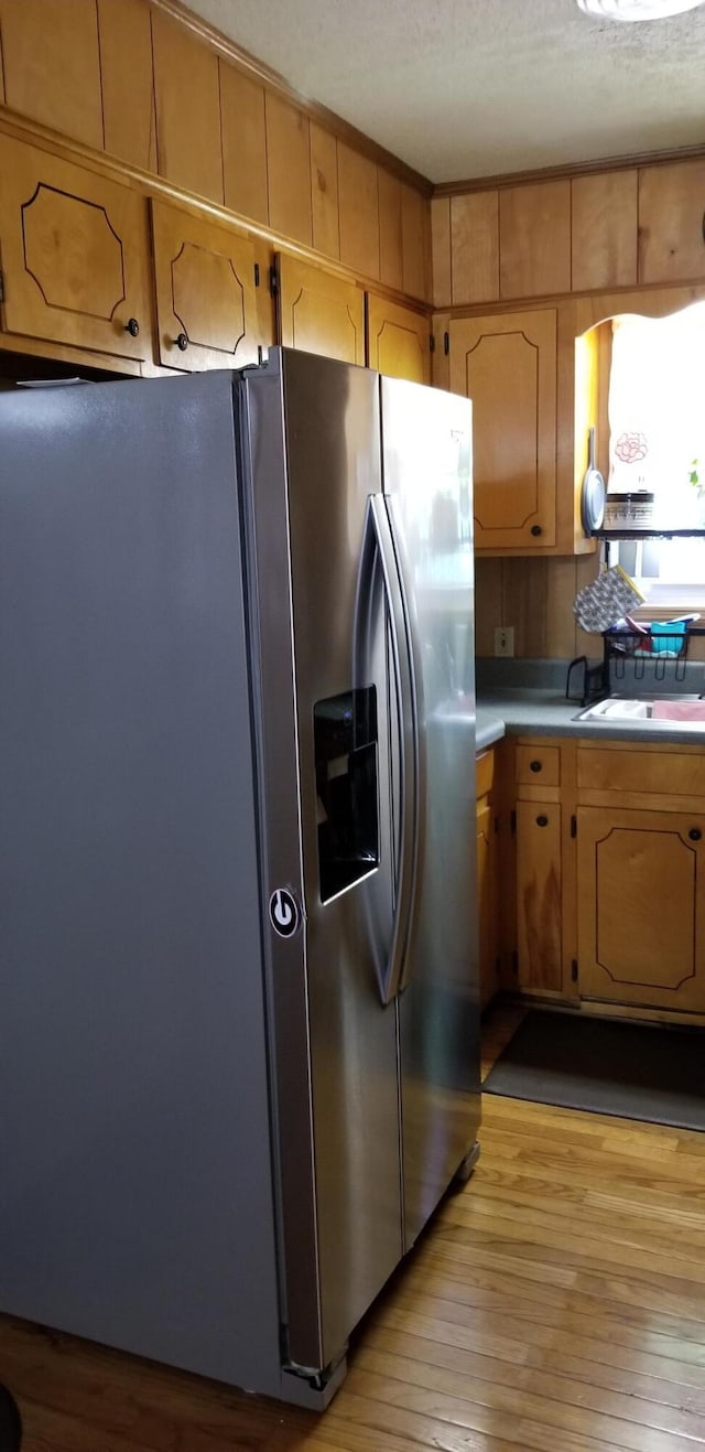 107 Kelly St, Walterboro, SC 29488 - kitchen featuring light wood finished floors, light countertops, and stainless steel refrigerator with ice dispenser