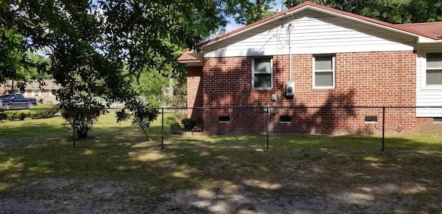 107 Kelly St, Walterboro, SC 29488 - view of property exterior featuring brick siding, fence, and crawl space