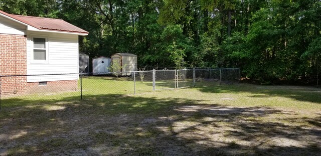 107 Kelly St, Walterboro, SC 29488 - view of yard featuring a storage shed, an outdoor structure, a gate, and fence
