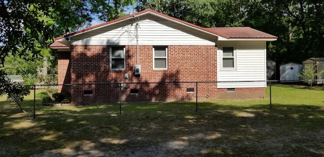 107 Kelly St, Walterboro, SC 29488 - view of side of property featuring fence, a storage shed, crawl space, a yard, and an outbuilding