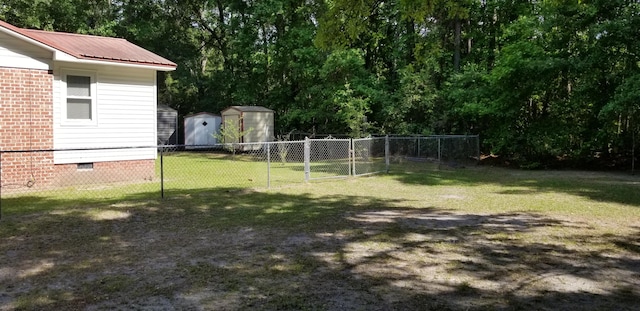 107 Kelly St, Walterboro, SC 29488 - view of yard featuring a storage shed, an outdoor structure, a gate, and fence