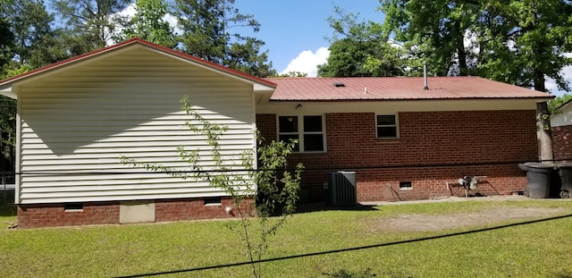 107 Kelly St, Walterboro, SC 29488 - view of side of home featuring metal roof, crawl space, a lawn, and central AC