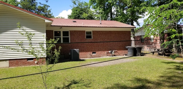 107 Kelly St, Walterboro, SC 29488 - view of side of property featuring central AC, crawl space, fence, metal roof, and a lawn