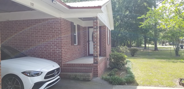107 Kelly St, Walterboro, SC 29488 - view of property exterior with a yard, fence, and brick siding