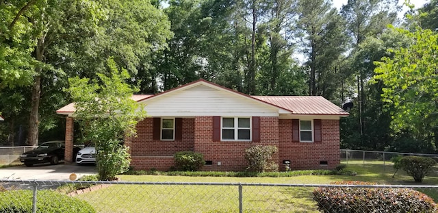 107 Kelly St, Walterboro, SC 29488 - view of side of property featuring a lawn, concrete driveway, crawl space, and metal roof