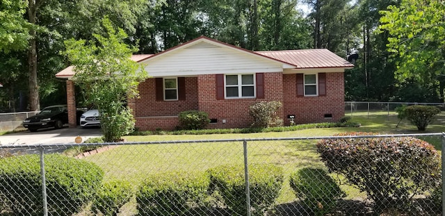107 Kelly St, Walterboro, SC 29488 - view of property exterior with a lawn, brick siding, crawl space, and metal roof