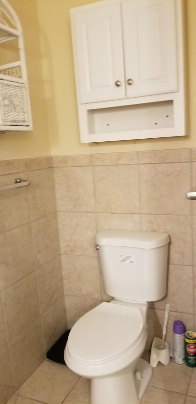 107 Kelly St, Walterboro, SC 29488 - bathroom featuring toilet, tile walls, tile patterned floors, and wainscoting
