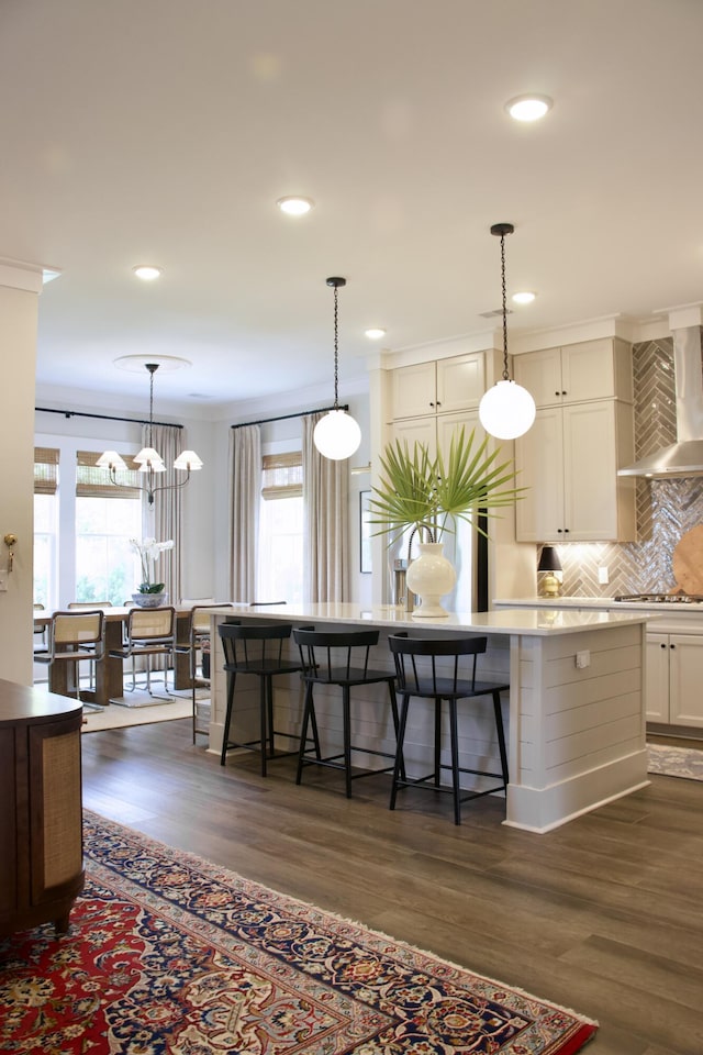 1723 Bolden Dr, Mount Pleasant, SC 29466 - kitchen featuring wall chimney exhaust hood, dark wood finished floors, stainless steel gas stovetop, decorative backsplash, and recessed lighting