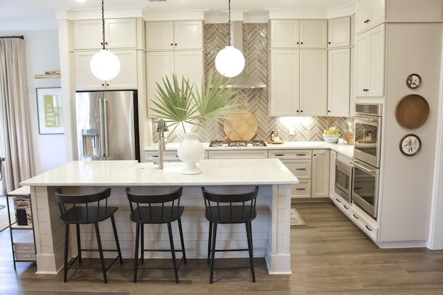 1723 Bolden Dr, Mount Pleasant, SC 29466 - kitchen featuring appliances with stainless steel finishes, decorative backsplash, a kitchen island with sink, crown molding, and hanging light fixtures