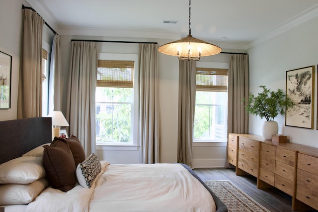 1723 Bolden Dr, Mount Pleasant, SC 29466 - bedroom with ornamental molding, dark wood-type flooring, and a chandelier