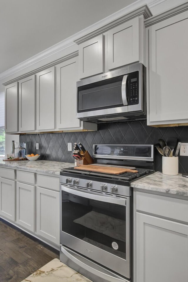 kitchen with decorative backsplash, stainless steel appliances, and dark wood-style flooring