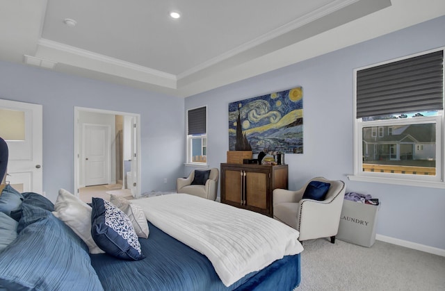 bedroom with a raised ceiling, crown molding, baseboards, and light carpet