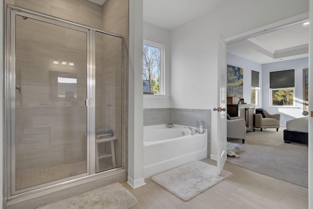 ensuite bathroom with a bath, baseboards, a stall shower, and connected bathroom