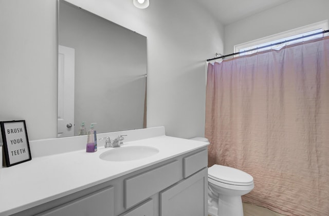 bathroom with vanity, toilet, and a shower with curtain