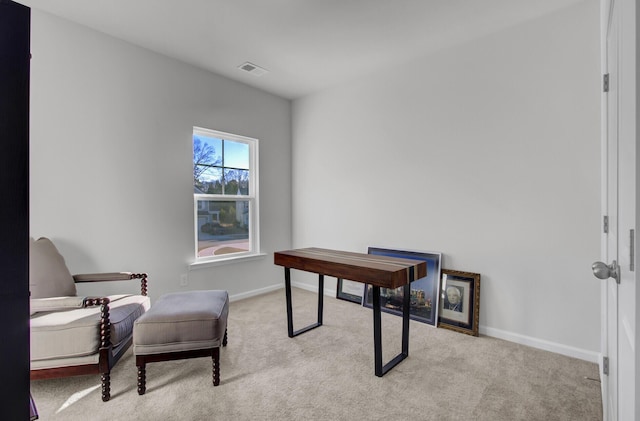 carpeted office space featuring visible vents and baseboards