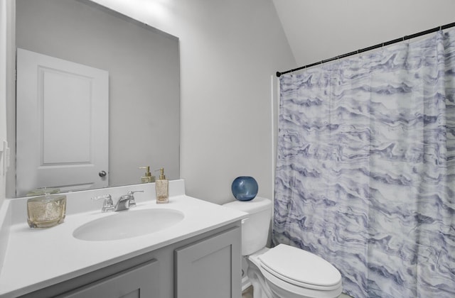 bathroom featuring toilet, curtained shower, and vanity