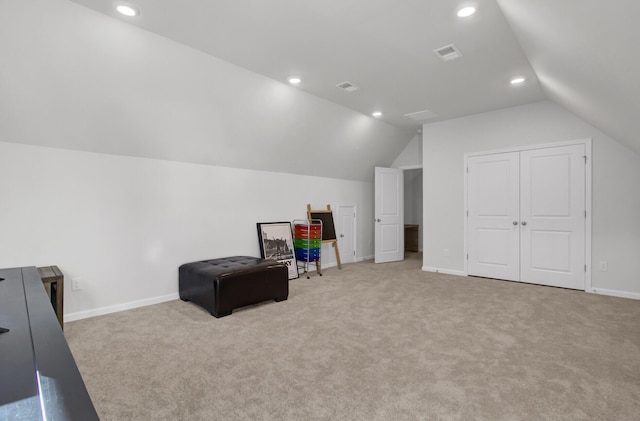 living area featuring visible vents, carpet flooring, baseboards, and vaulted ceiling