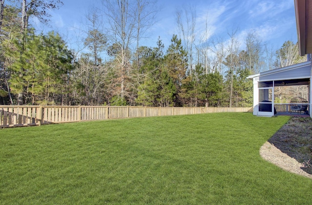 view of yard with a sunroom and fence