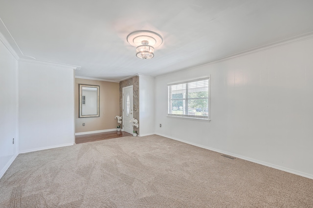 unfurnished room featuring light carpet and crown molding