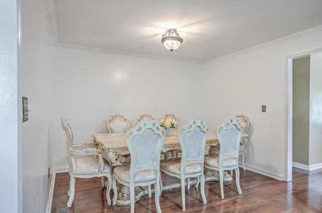 dining room with wood-type flooring and crown molding