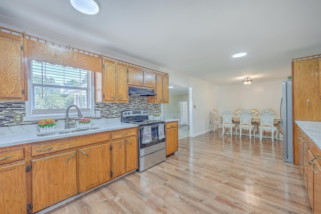 kitchen with light hardwood / wood-style floors, backsplash, stainless steel appliances, crown molding, and sink