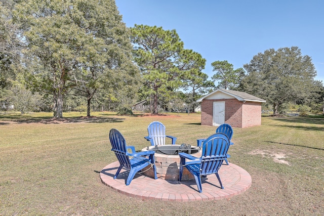 view of yard featuring an outdoor fire pit, a storage unit, and a patio area