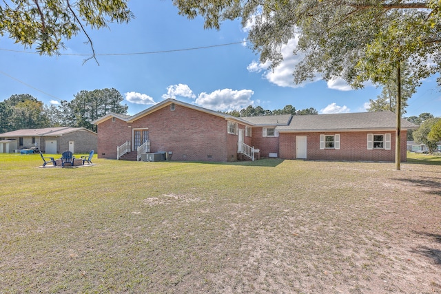 rear view of property featuring a lawn