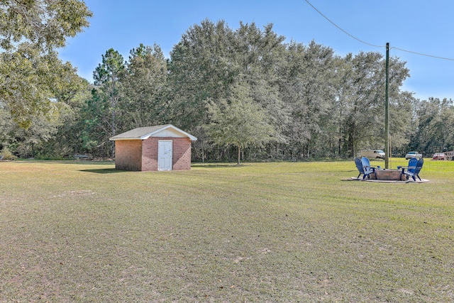 view of yard featuring a storage shed and a fire pit