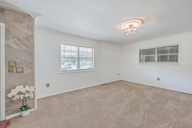 carpeted empty room with ornamental molding