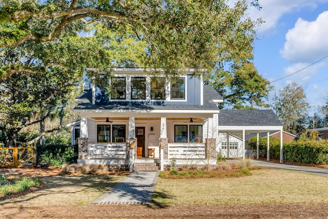 view of front facade featuring a carport, driveway, covered porch, and a front yard