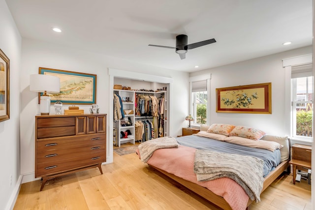 bedroom with a ceiling fan, recessed lighting, a closet, light wood finished floors, and a spacious closet