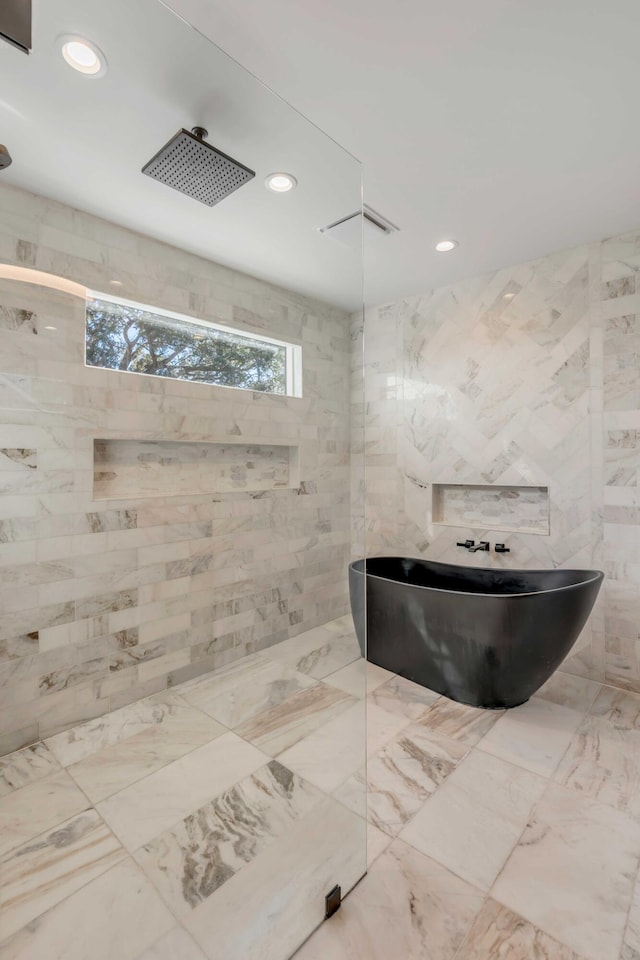 bathroom with a tile shower, recessed lighting, and a freestanding bath