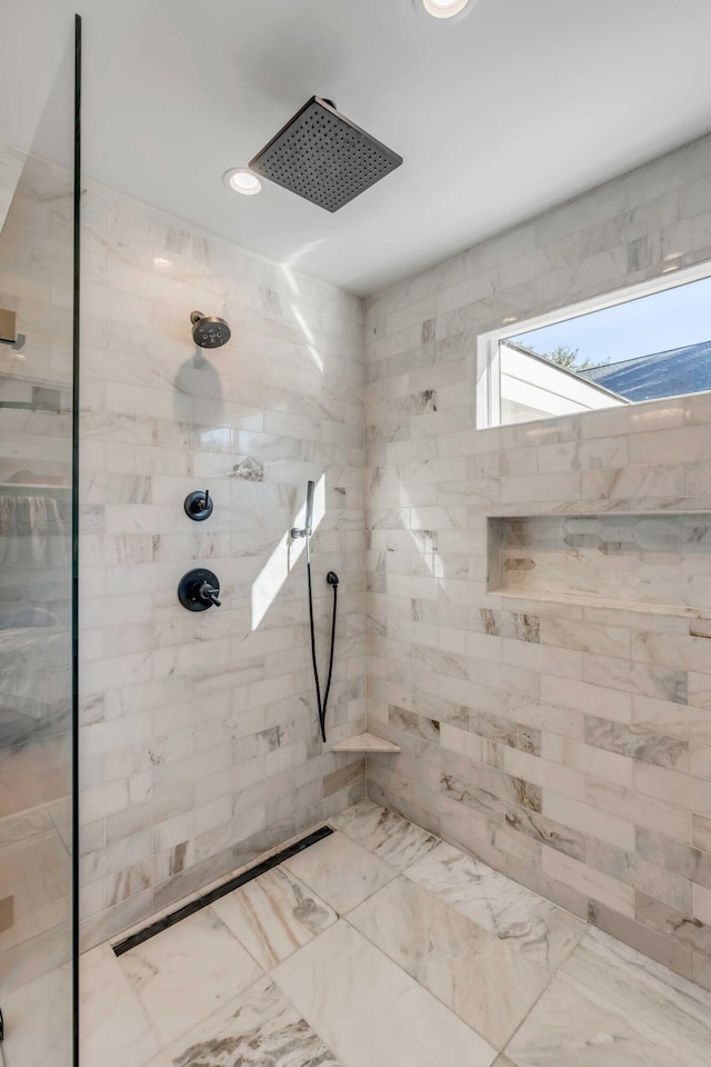 bathroom with recessed lighting, marble finish floor, and a tile shower