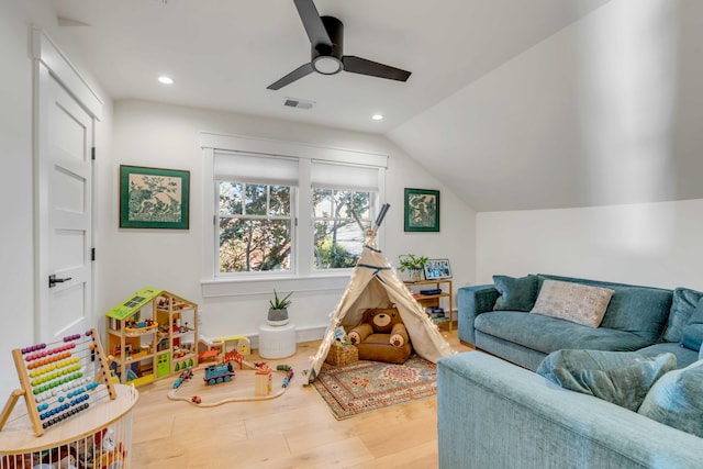 playroom featuring lofted ceiling, recessed lighting, wood finished floors, and visible vents